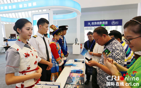 图片默认标题_fororder_羌族服饰与现代职业服饰结合的北川通航展区展台，同样吸引观众驻足、停留。