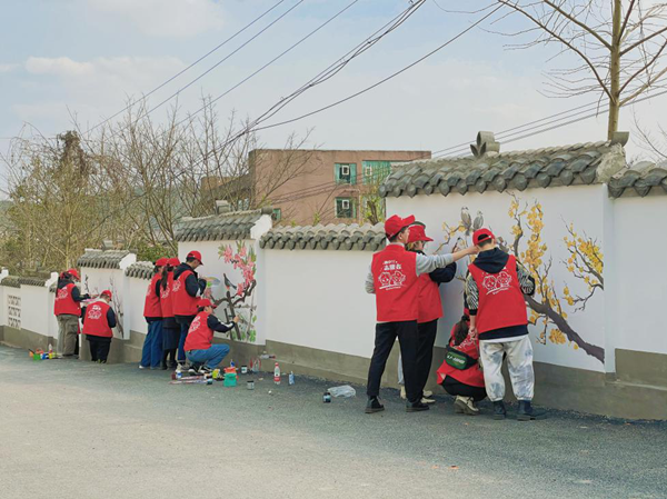 重庆北碚：西南大学大学生“学雷锋”义务画墙绘 装点美丽乡村