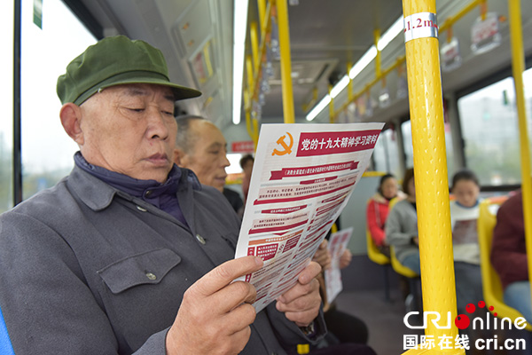 图片默认标题_fororder_10月31日，绵竹市民在市内电动公交车上阅读十九大的宣传资料。.JPG
