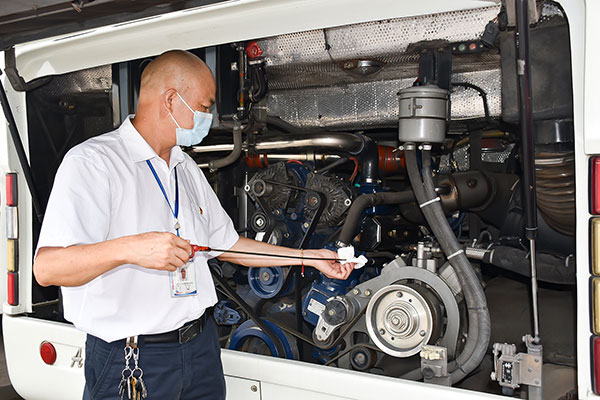 四川自贡:为20余万乘客保驾护航 劳动模范甘德富19年驾驶零事故_fororder_4甘德富出发前检查机油(摄影-赵丽)