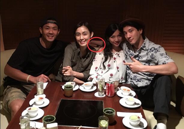 Lee Hom black with his wife behind the party holding the hands of the tight betrayed them