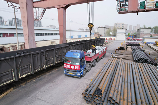 四川攀西电网优化工程10万吨塔材的“辗转进山路”_fororder_工人正在将她才向火车转运--摄影-李景林