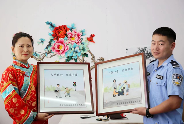 河北丰宁:非遗“布糊”艺术助力交通安全 传递文明出行理念_fororder_郝如香将制作好的“交通布糊”作品赠送给交警大队工作人员 拍摄程里
