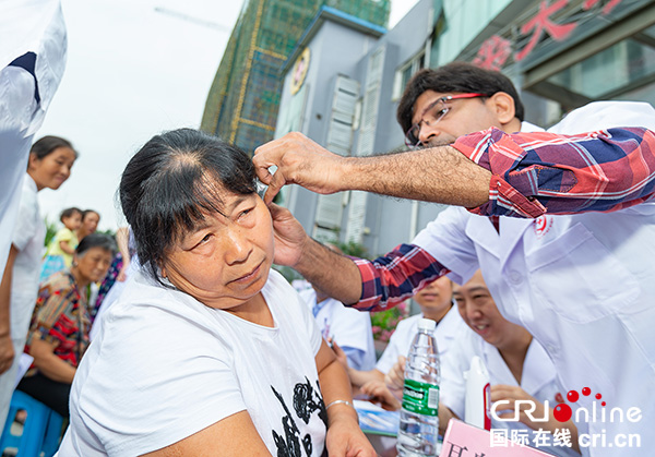 图片默认标题_fororder_印度耳鼻喉科医生帕万•辛格哈尔为村民认真诊断（摄影-廖志全）