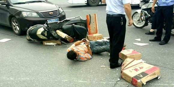 长沙男子车祸被撞后躺地上玩手机 交警一脸无奈