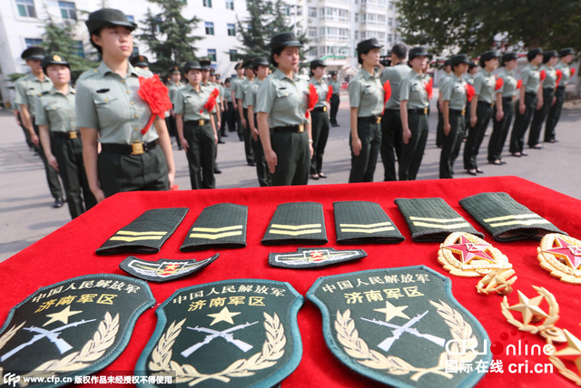济南军区某部退伍女兵参加向军旗告别仪式,她们卸下帽徽,领花,恋恋不