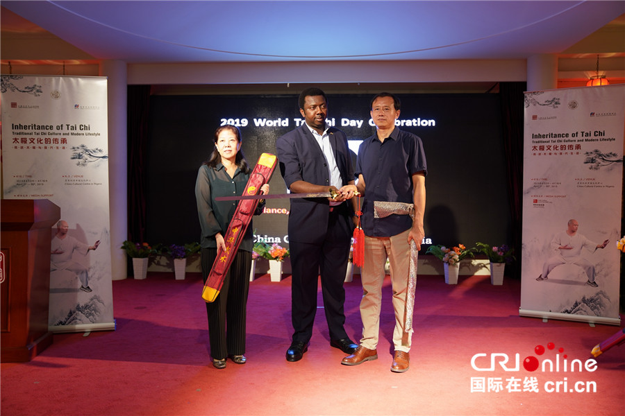 副主任贾晓玲(左一)向尼日利亚武术协会主席艾德瑞米赠送纪念宝剑