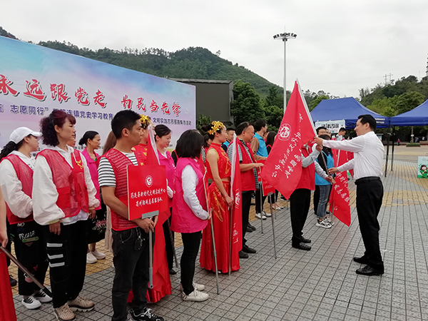“幸福筠连 志愿同行”暨“我为群众办实事”文明实践志愿服务集市活动举行_fororder_筠连县委常委、宣传部部长彭强向志愿服务队授旗--筠连县委宣传部供图