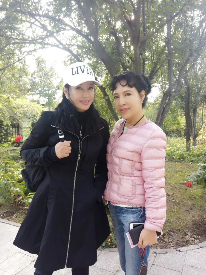 组图：刘晓庆假日游玩笑容灿烂 与妹妹拍照遭狗狗嫉妒飞扑