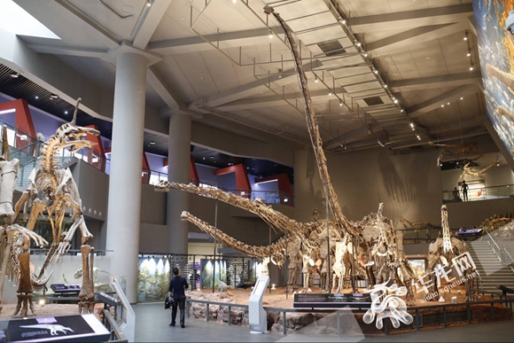 【文化 标题摘要】穿越回侏罗纪世纪 记者自然博物馆和“恐龙”合影