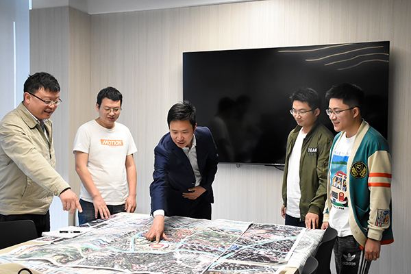 文继涛：充分发挥专业优势作用 将城市规划打造得更加美丽_fororder_文继涛（中）带领同事查看城市规划图