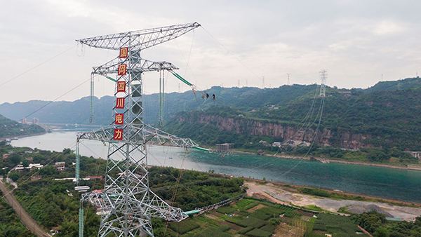 攀西电网500千伏优化工程线路成功跨越金沙江_fororder_500千伏建叙线跨江施工现场，电力工人正在走线安装附件-供图-周毅