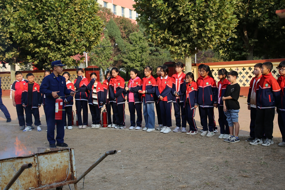 图片默认标题_fororder_消防队员为学生展示灭火器的使用方法 摄影 袁野.JPG