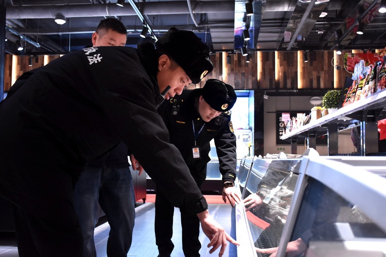 河北清苑：严把食品安全关 保障“舌尖上的安全”_fororder_执法人员查看冷冻食品存储设备。赵琪摄.JPG