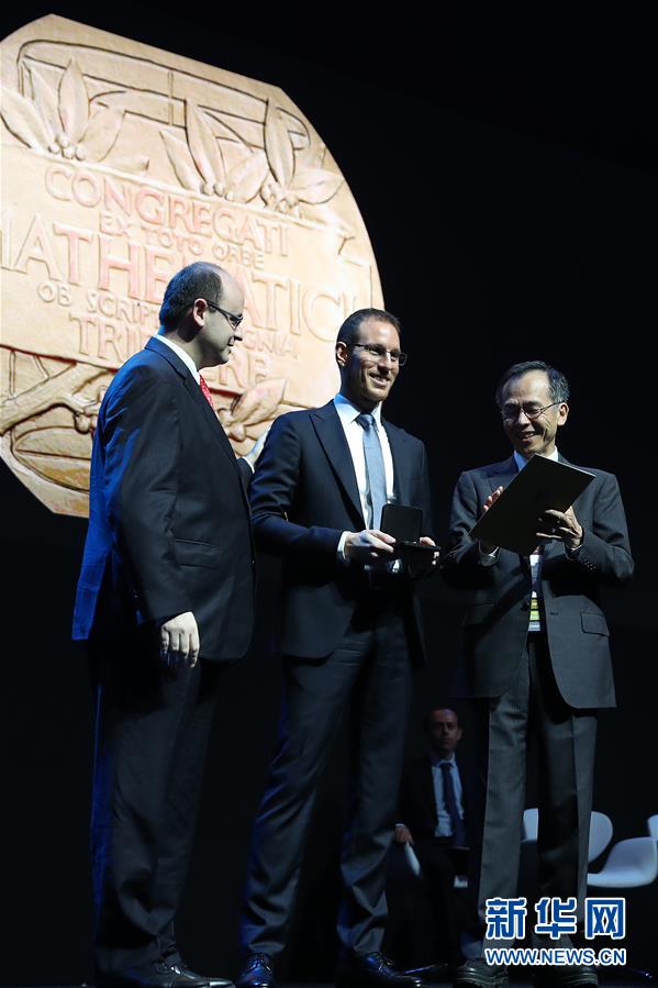 大学教授阿莱西奥·菲加利(中)在国际数学家大会开幕式上获颁菲尔兹奖